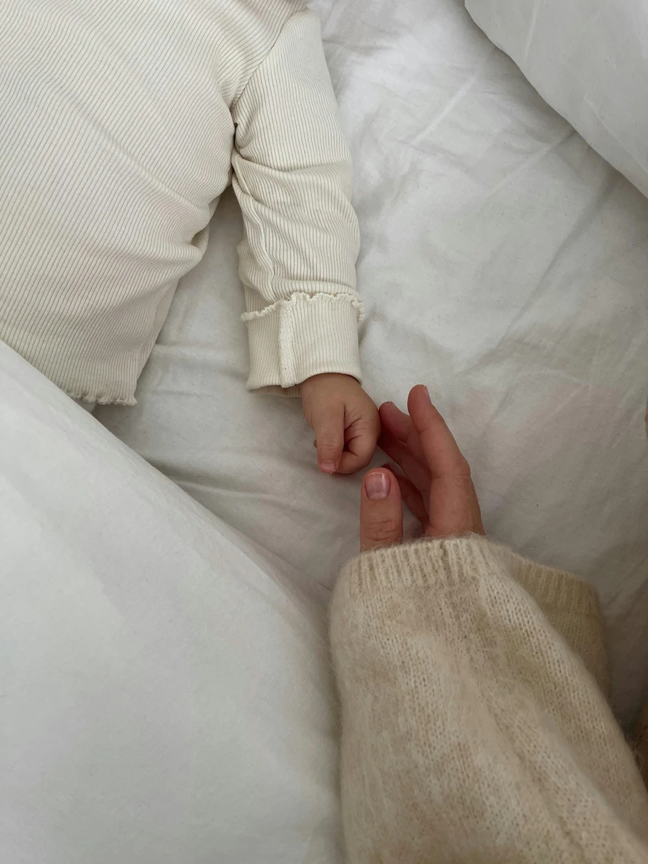 A parent and child holding hands